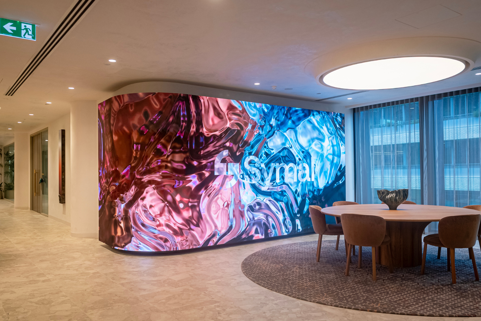 Custom Absen curved 8.25m x 2.5m K1.8 V3 LED wall at client's reception area. Inavate APAC 2026 Corporate Project of the Year Finalist with Symal.