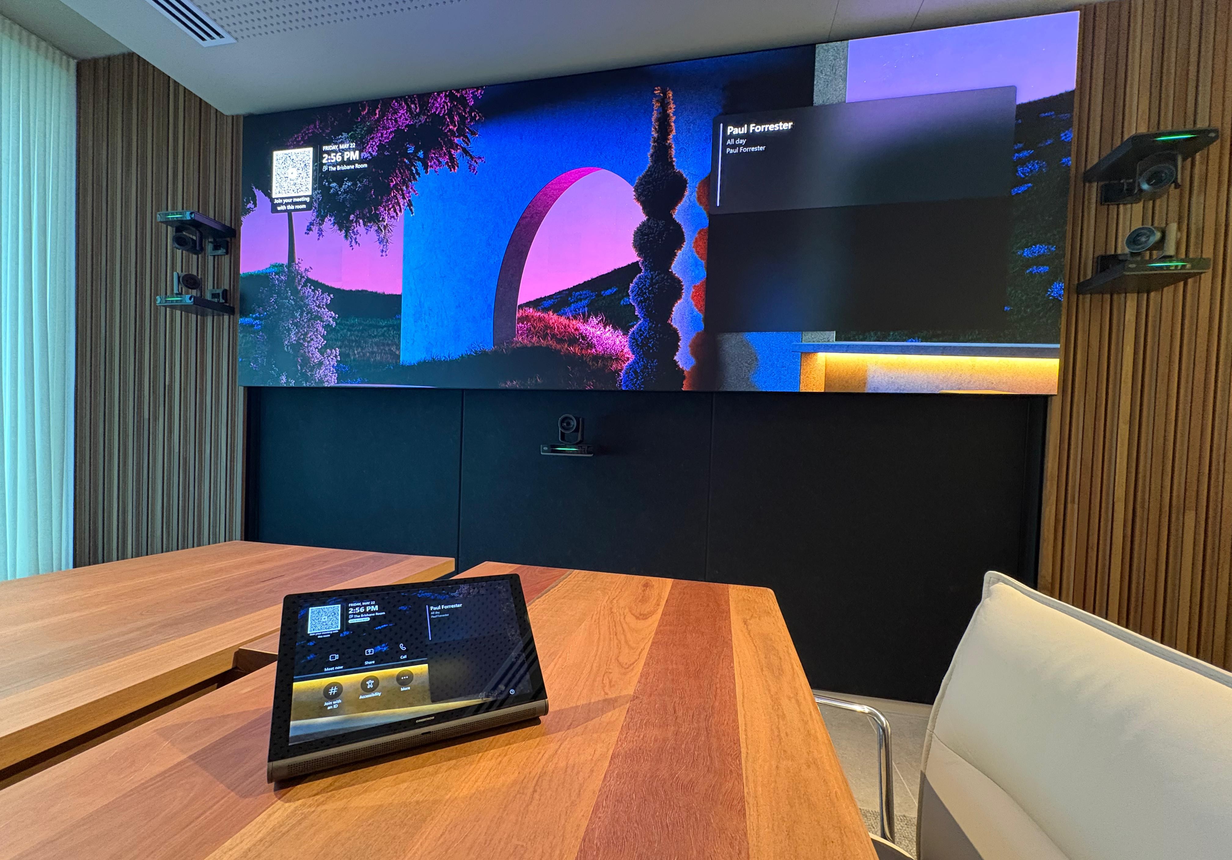 Large Microsoft Teams Boardroom showcasing Sharp LED wall, Crestron 1Beyond PTZ cameras, Crestron TS10 Tabletop Touch Controller, and Sennheiser TCCM Ceiling Microphone.