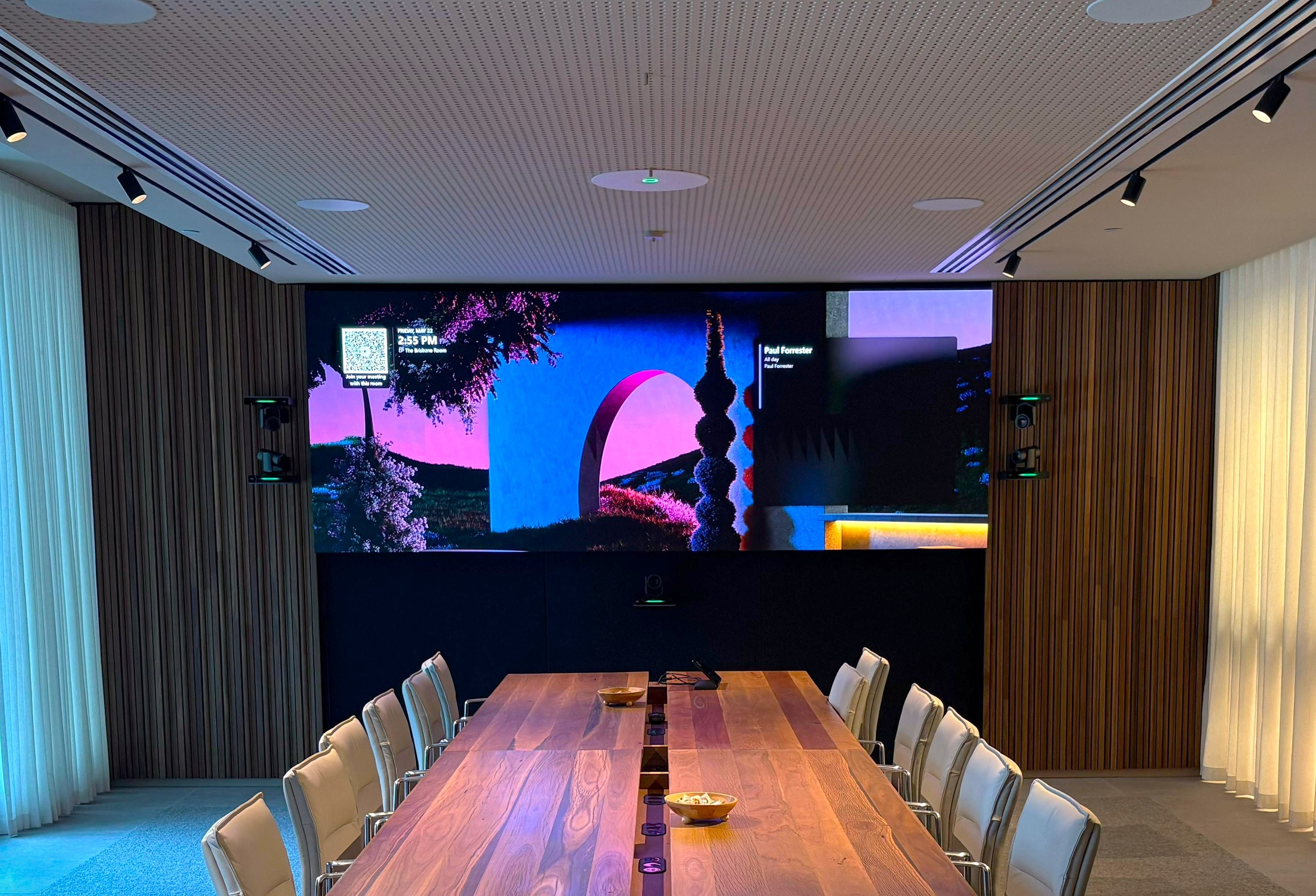 Large Microsoft Teams Boardroom showcasing Sharp LED wall, Crestron 1Beyond PTZ cameras, Crestron TS10 Tabletop Touch Controller, and Sennheiser TCCM Ceiling Microphone.