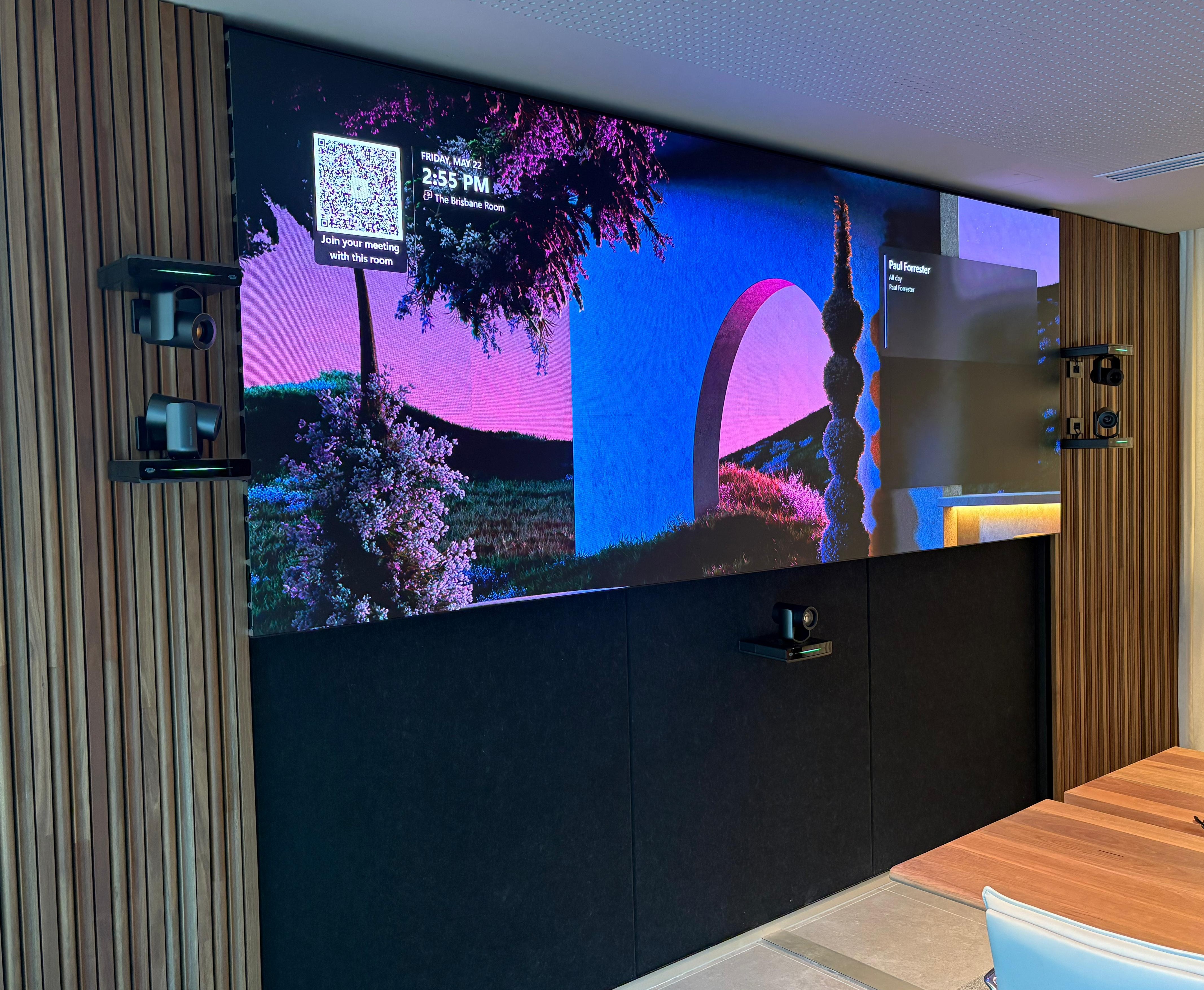 Large Microsoft Teams Boardroom showcasing Sharp LED wall, Crestron 1Beyond PTZ cameras, Crestron TS10 Tabletop Touch Controller, and Sennheiser TCCM Ceiling Microphone.