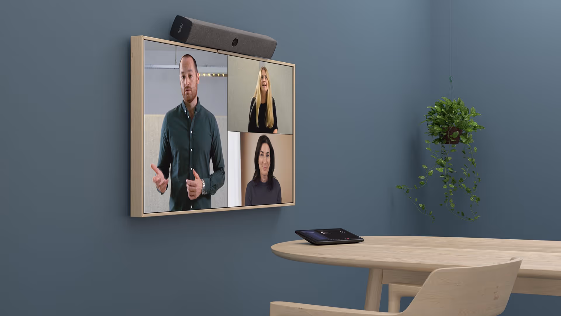 Small video conferencing room with wall-mounted TV, Neat bar, and Microsoft Teams tabletop device