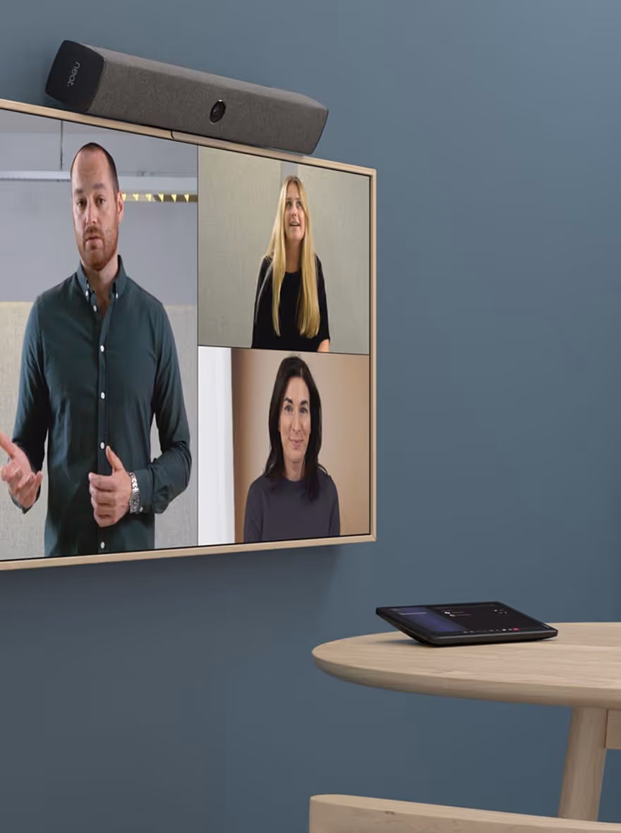 Small video conferencing room with wall-mounted TV, Neat bar, and Microsoft Teams tabletop device
