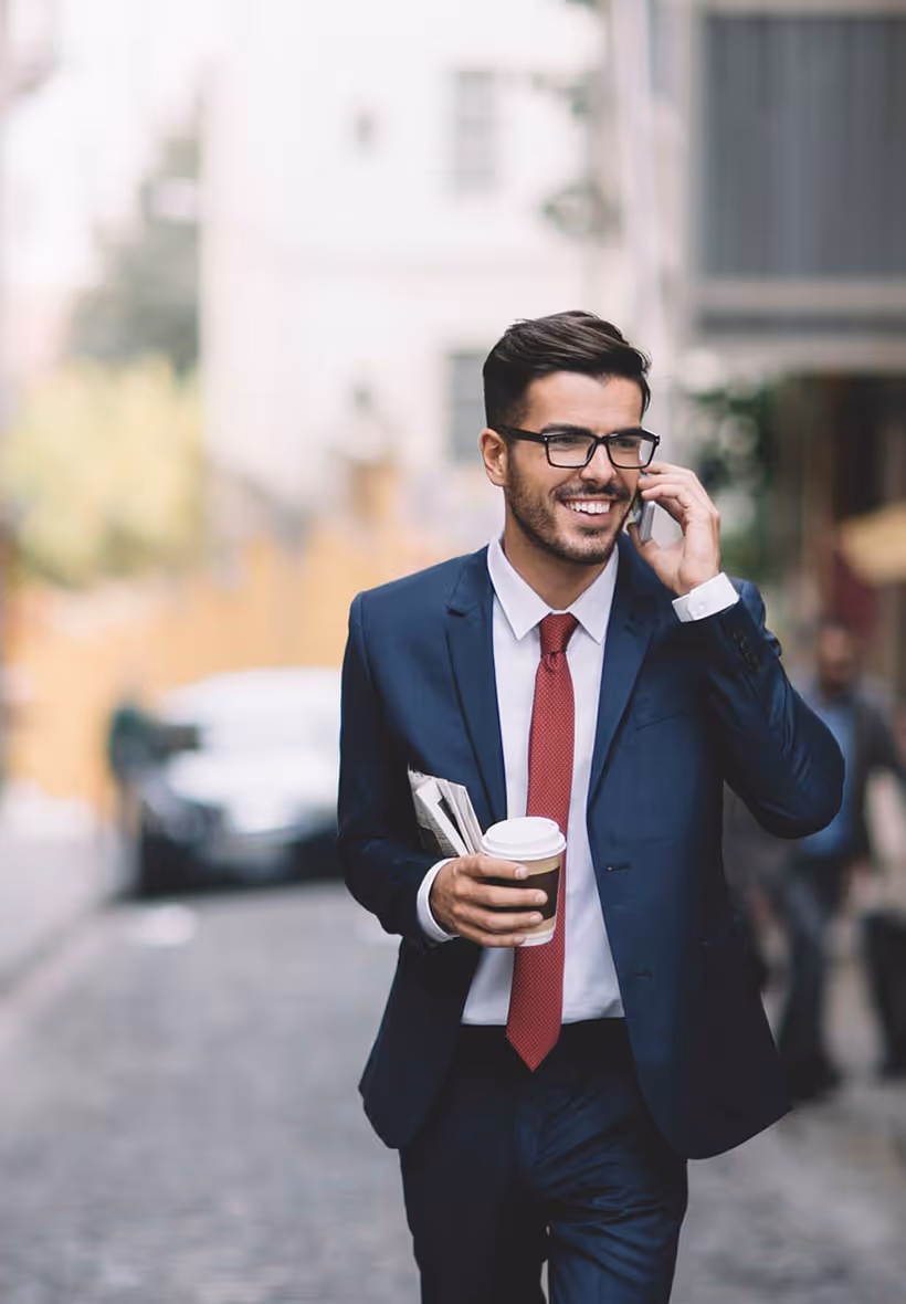 Man in suit smiling and talking on phone