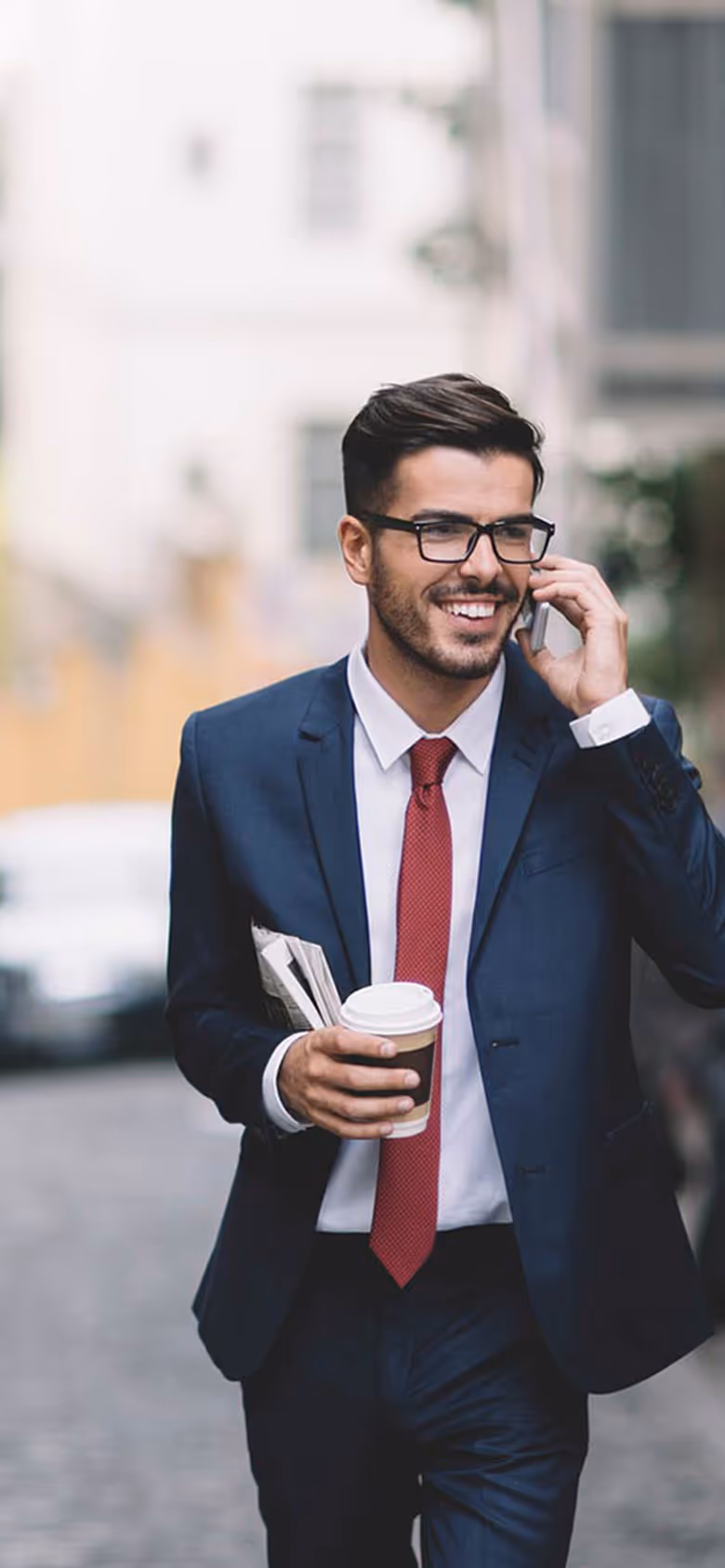 Man in suit smiling and talking on phone