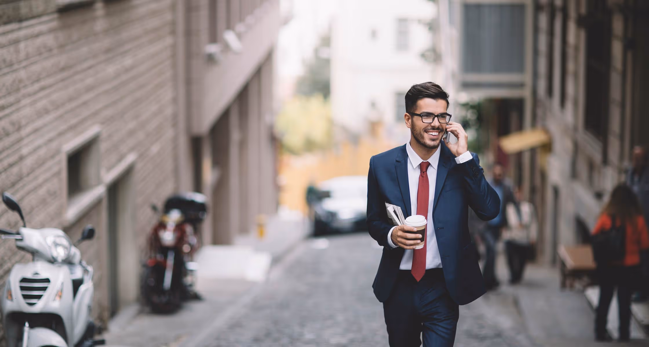 Man in suit smiling and talking on phone