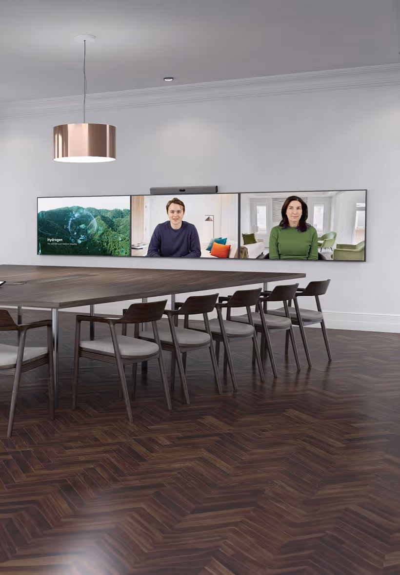 Zoom Rooms signature room with large meeting table and three wall-mounted displays