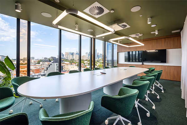Brightly lit modern boardroom with green interior scheme at Linktree offices