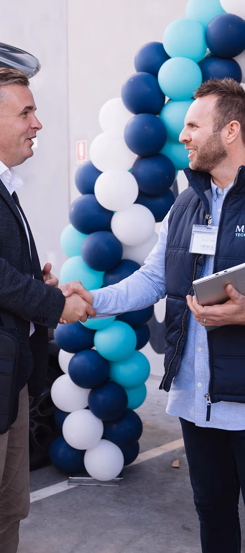 Merge Technologies director Marty Clark greeting clients at a corporate event