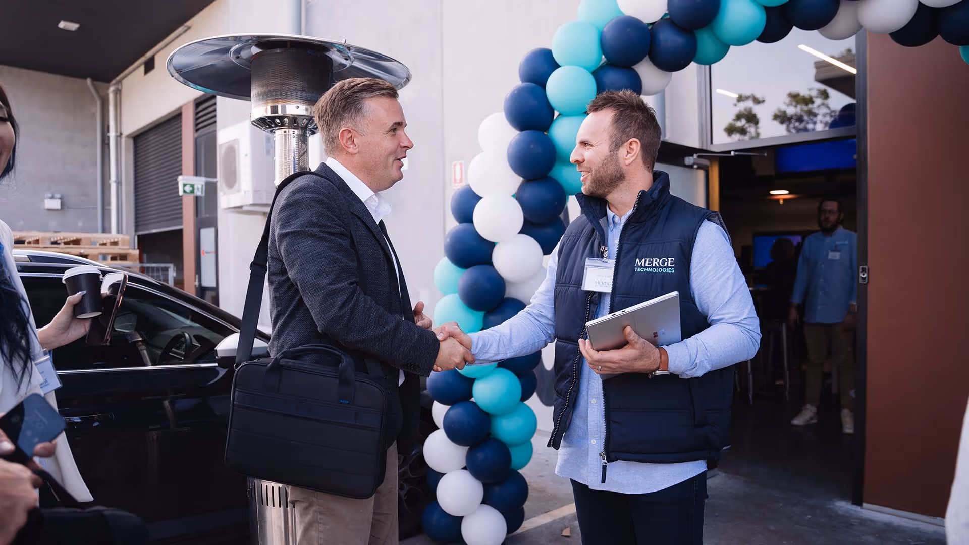 Merge Technologies director Marty Clark greeting clients at a corporate event