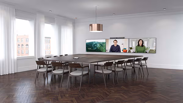 Zoom Rooms signature room with large meeting table and three wall-mounted displays