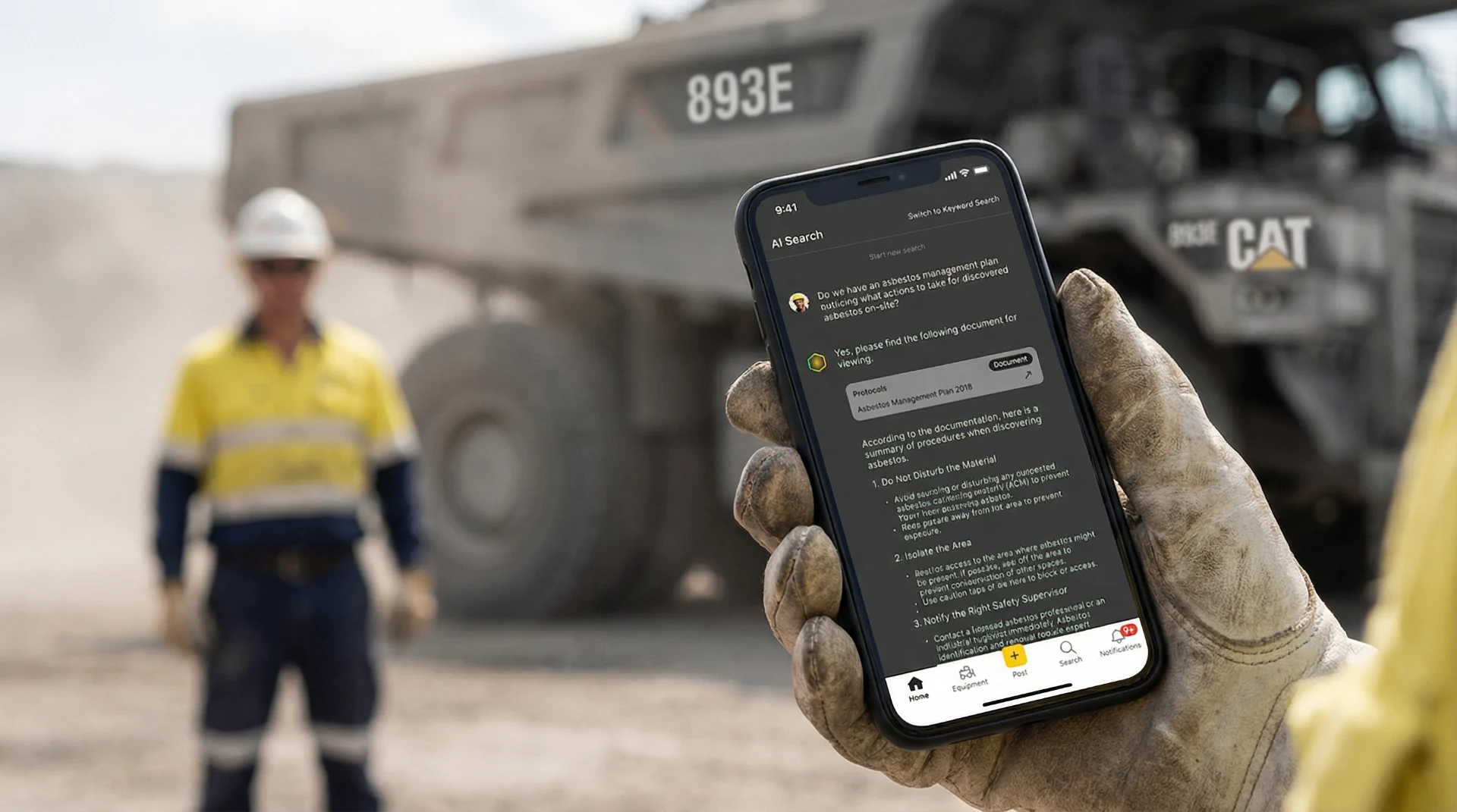 Mine worker using Torqn Docs on a phone beside a haul truck