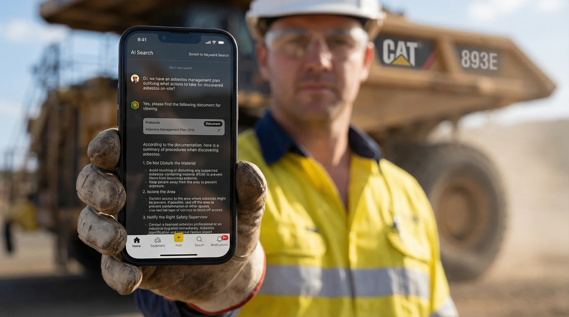 Phone with Torqn Docs answer in front of a haul truck