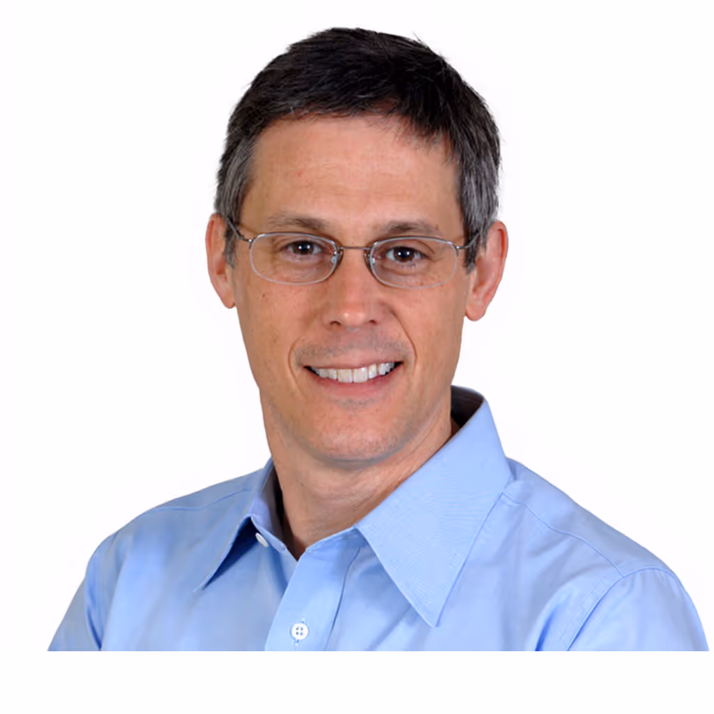 Headshot of Ed in glasses and a light blue shirt.