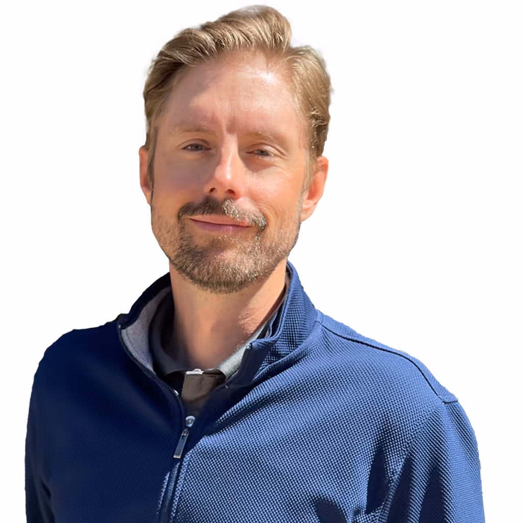 Headshot of David wearing a blue zip-up jacket.