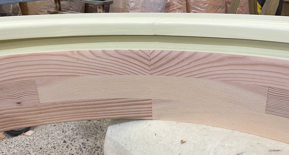 Detail of round window interior showing curved laminated timber