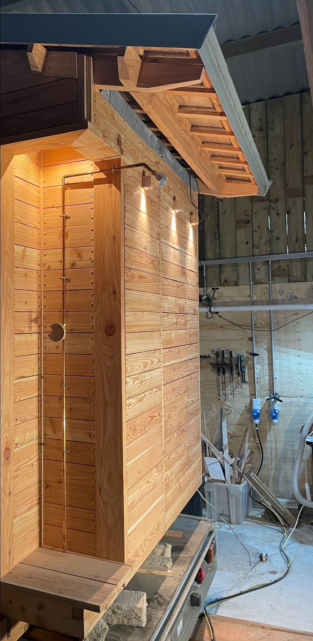 Exterior shower on The Temple of Sweat, a sauna by Sam Ludgate Bloom.