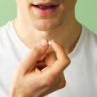 Man with a pill in hand