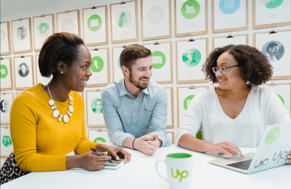 People chatting at a desk
