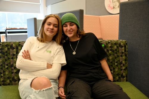 Two TSS students sitting on a green couch