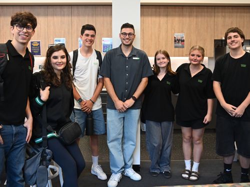 Teacher stood in the middle of a group of students