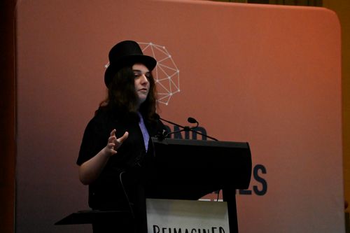 Student giving a speech at a lecturn onstage