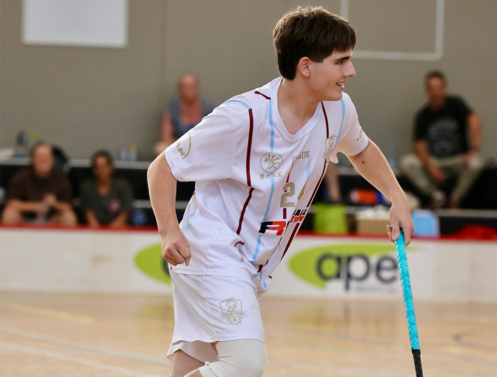 Student in floorball kit high-fiving team mates