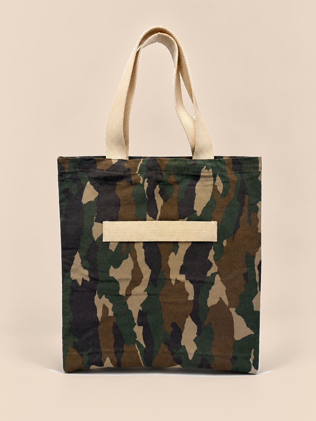Bold camouflage in olive, brown, sand and black. This roomy everyday tote is made from printed canvas, with natural cotton webbing handles and a cotton strap across the front.

It's big enough for a market haul, a beach towel or a yoga kit. The open top makes it easy to pack, the long cotton handles sit comfortably on the shoulder, and the front strap holds a yoga mat or umbrella. Made to replace single-use bags, day after day.

Material: 100% cotton