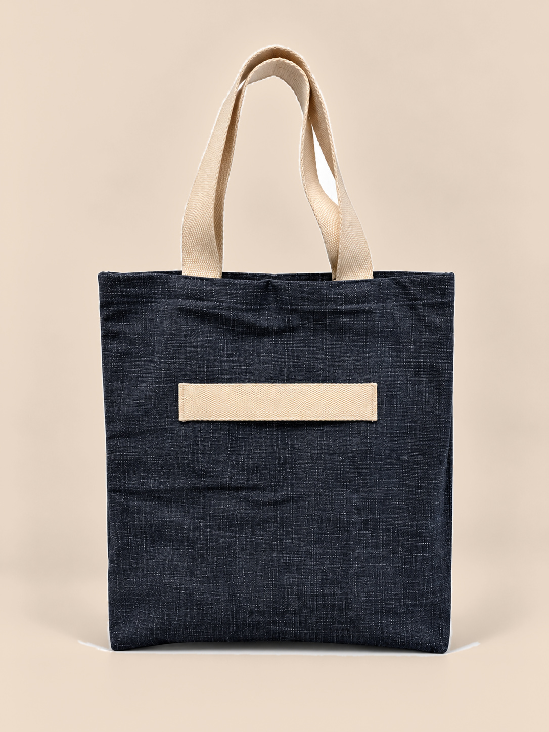 Everyday denim with a soft, textured slub weave. This roomy tote is deep navy, with natural cotton webbing handles and a cotton strap across the front.

It's big enough for a market haul, a beach towel or a yoga kit. The open top makes it easy to pack, the long cotton handles sit comfortably on the shoulder, and the front strap holds a yoga mat or umbrella. Made to replace single-use bags, day after day.

Material: 100% cotton