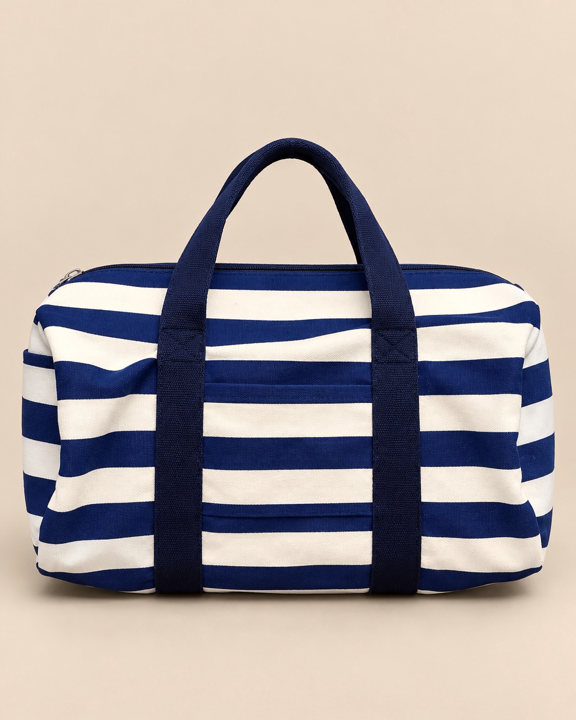 Bold navy and cream stripes with a nautical feel. This roomy duffle is made from sturdy striped cotton canvas with navy cotton webbing handles, sized for a weekend away, the gym or an overnight trip.

The full-length zip top makes packing easy, the front slip pocket keeps your phone, tickets or passport close at hand, and the end pocket holds a water bottle or umbrella. An interior zip pocket looks after small essentials. Made to replace single-use bags, day after day.

Material: 100% cotton
