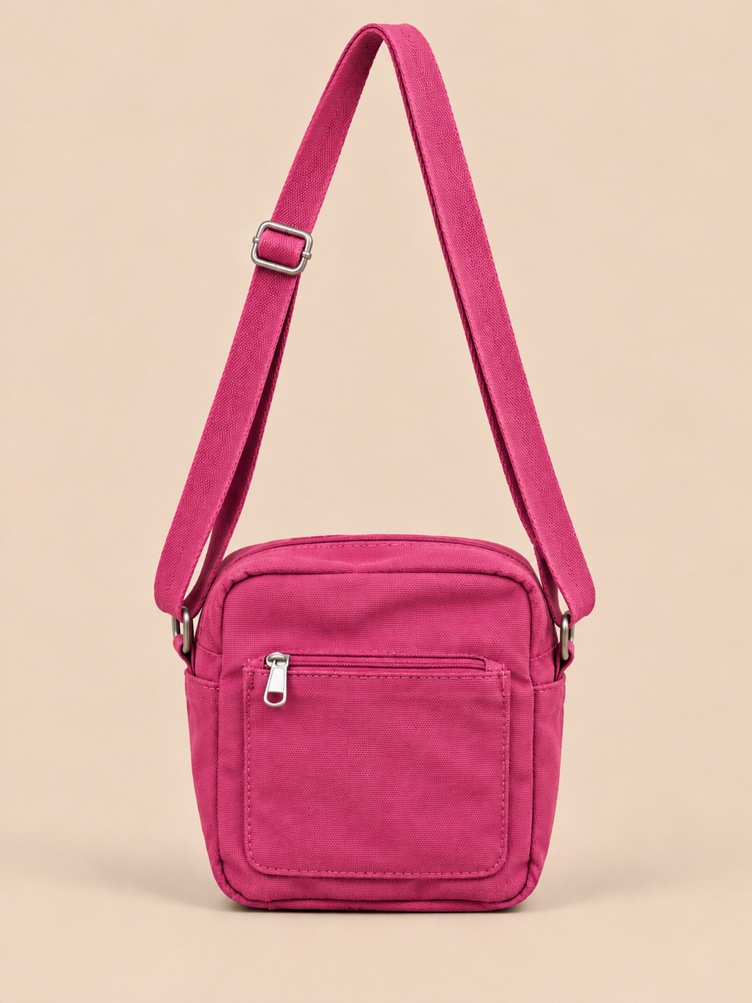 A vivid magenta pink that brings a pop of colour to any outfit. This compact cross body bag is made from sturdy cotton canvas with a matching adjustable strap, sized for your phone, wallet, keys and passport.

It has two outer pockets: a zippered pocket on one side and a pocket with a magnetic button on the other, so the things you reach for most are always close at hand. Wear it across your body and keep your hands free, day after day.

Material: 100% cotton