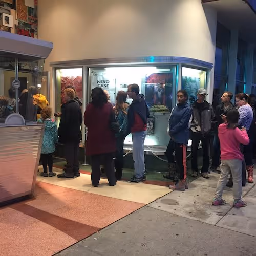 People queuing outside cinema