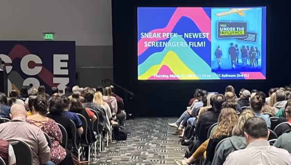 conference attendees watching screenagers