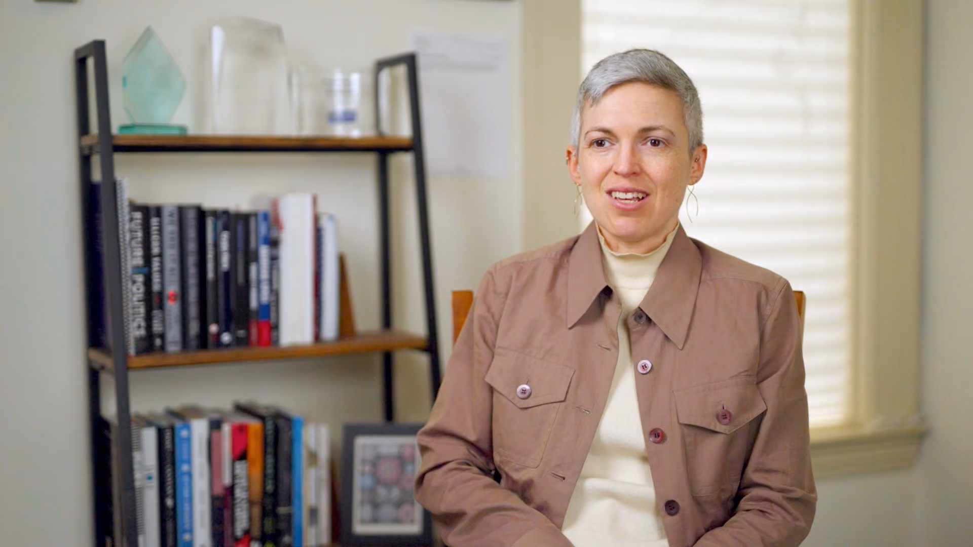 Peggy Orenstein speaking to camera sat in front of a packed bookcase