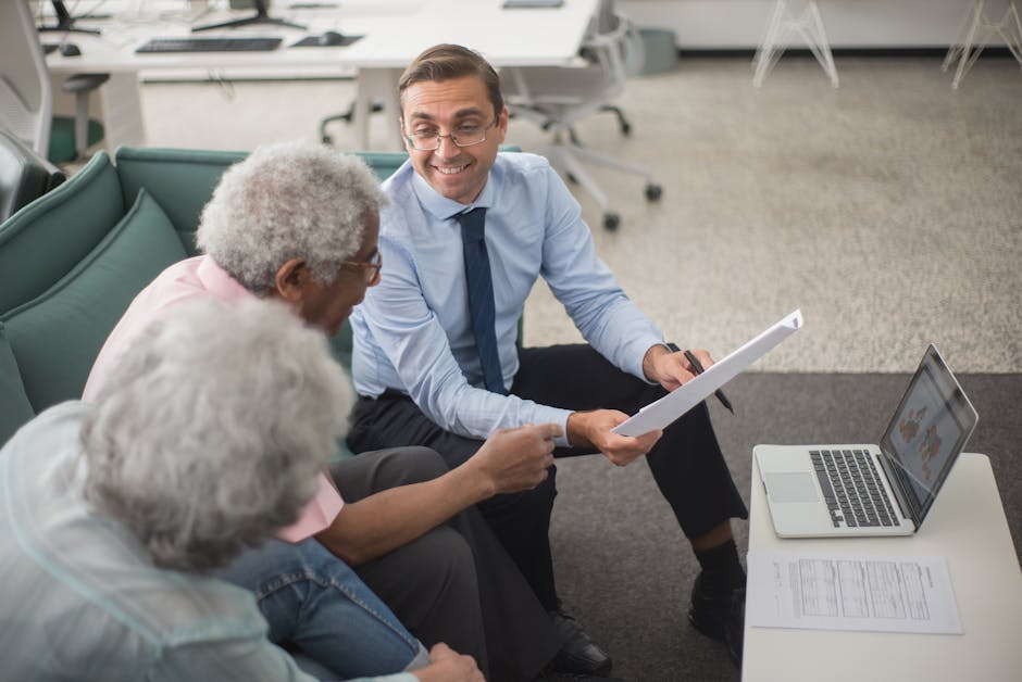 Consultant working with a business owner at a computer - Security Compliance Services