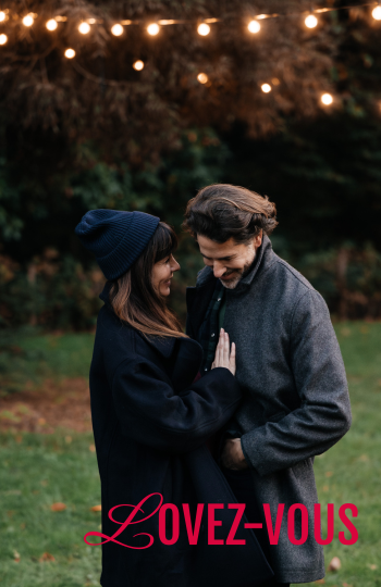 A couple embrace under guinguette lights at dusk - at the Domaine de Maffliers, one hour from Paris.