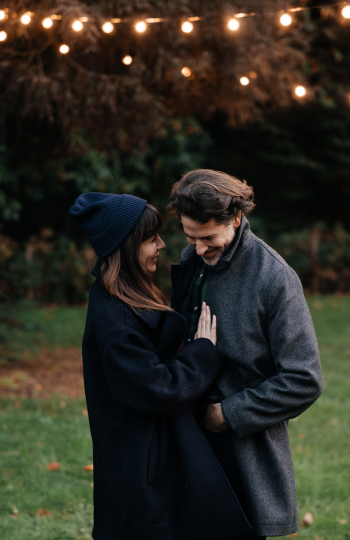 A family with two parents and one child are in a movie theater.