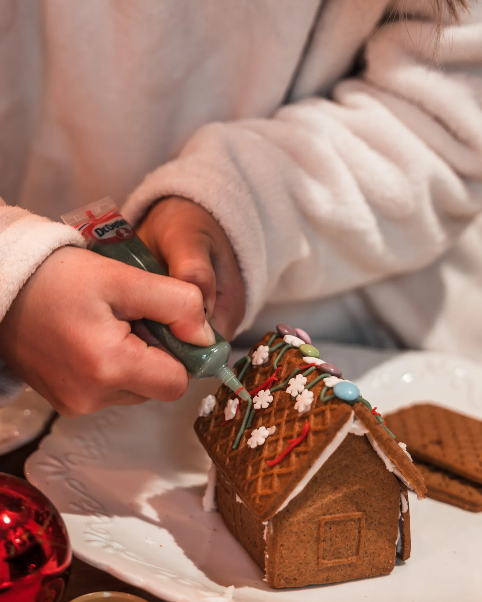 Un enfant réalise une maison en pain d'épices