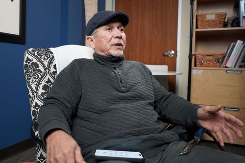 A white-haired man, Steve Alcala, speaks while leaning back in an armchair.