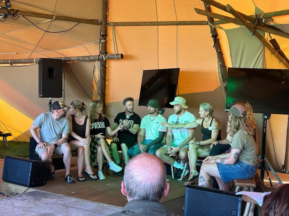 Steven Kelly speaking on stage at The Bushcraft Show with Naked and Afraid and Alone survivalists