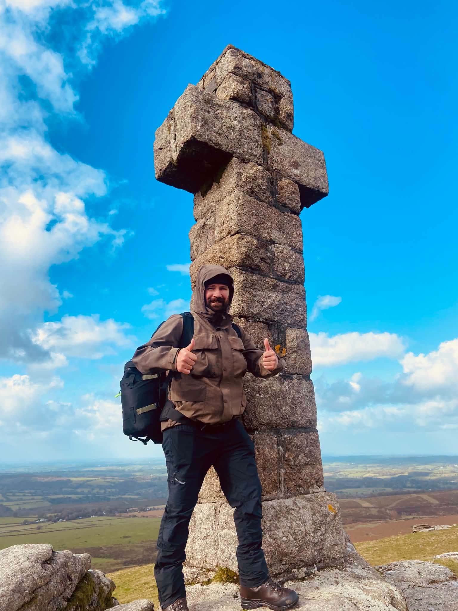 Steven Kelly beside the stone cross at Widgery Cross on Dartmoor
