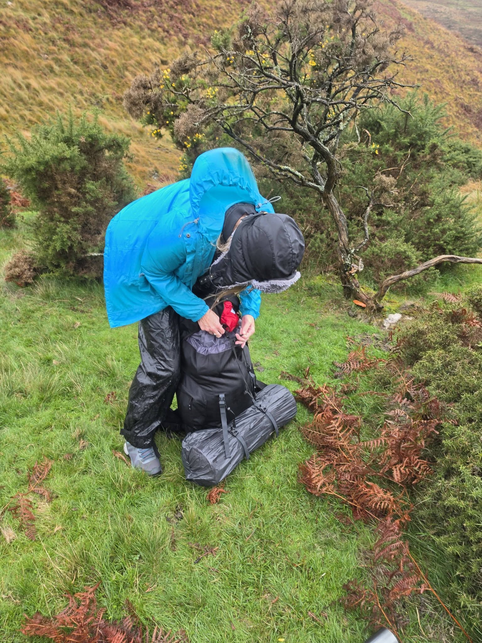 Jenny packing her rucksack in waterproof clothing on Dartmoor
