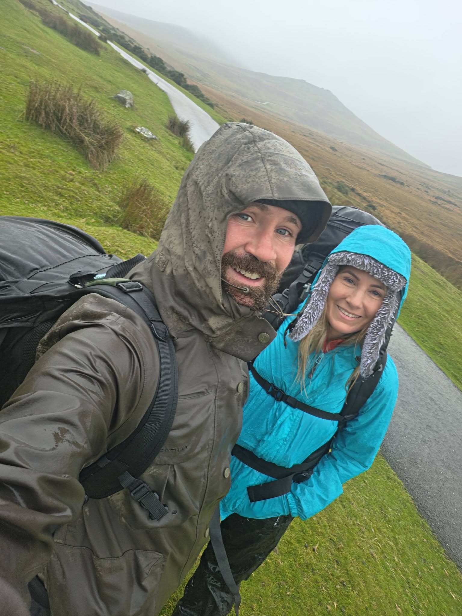 Steven Kelly and Jenny hiking across Dartmoor in wet weather
