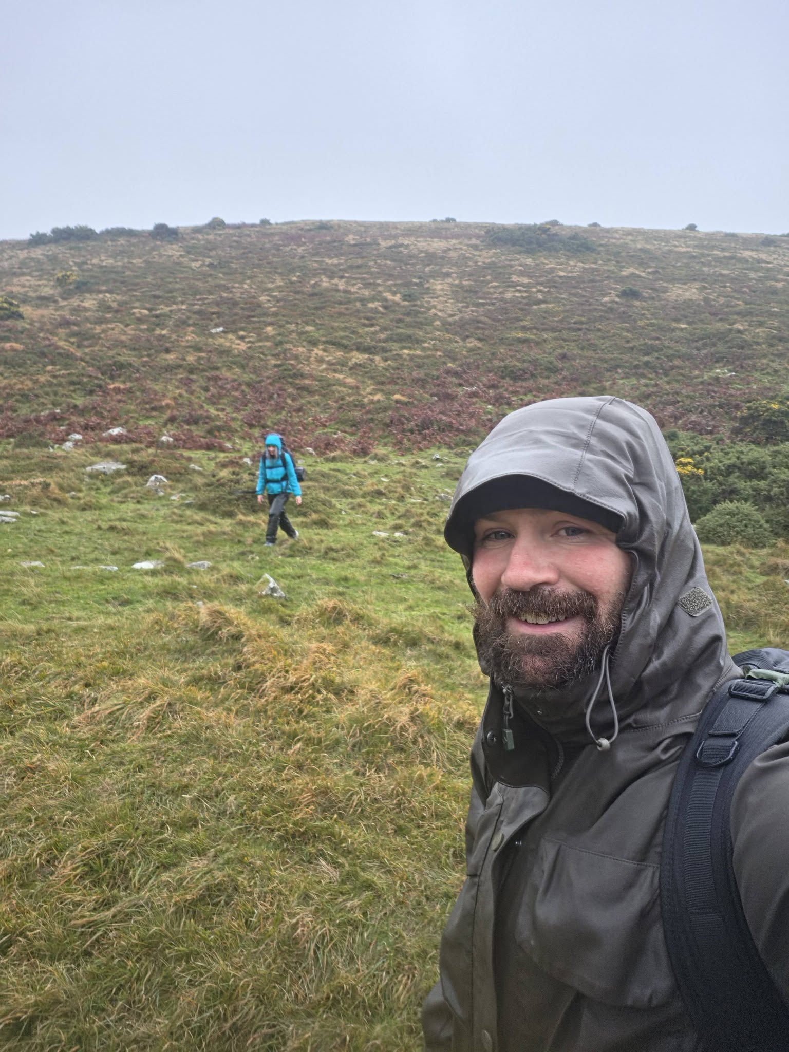 Steven Kelly on Dartmoor with Jenny walking in her blue waterproof jacket