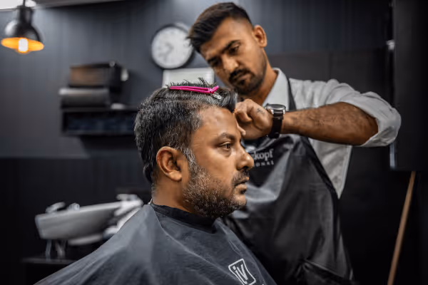 A barber giving a customer a haircut

