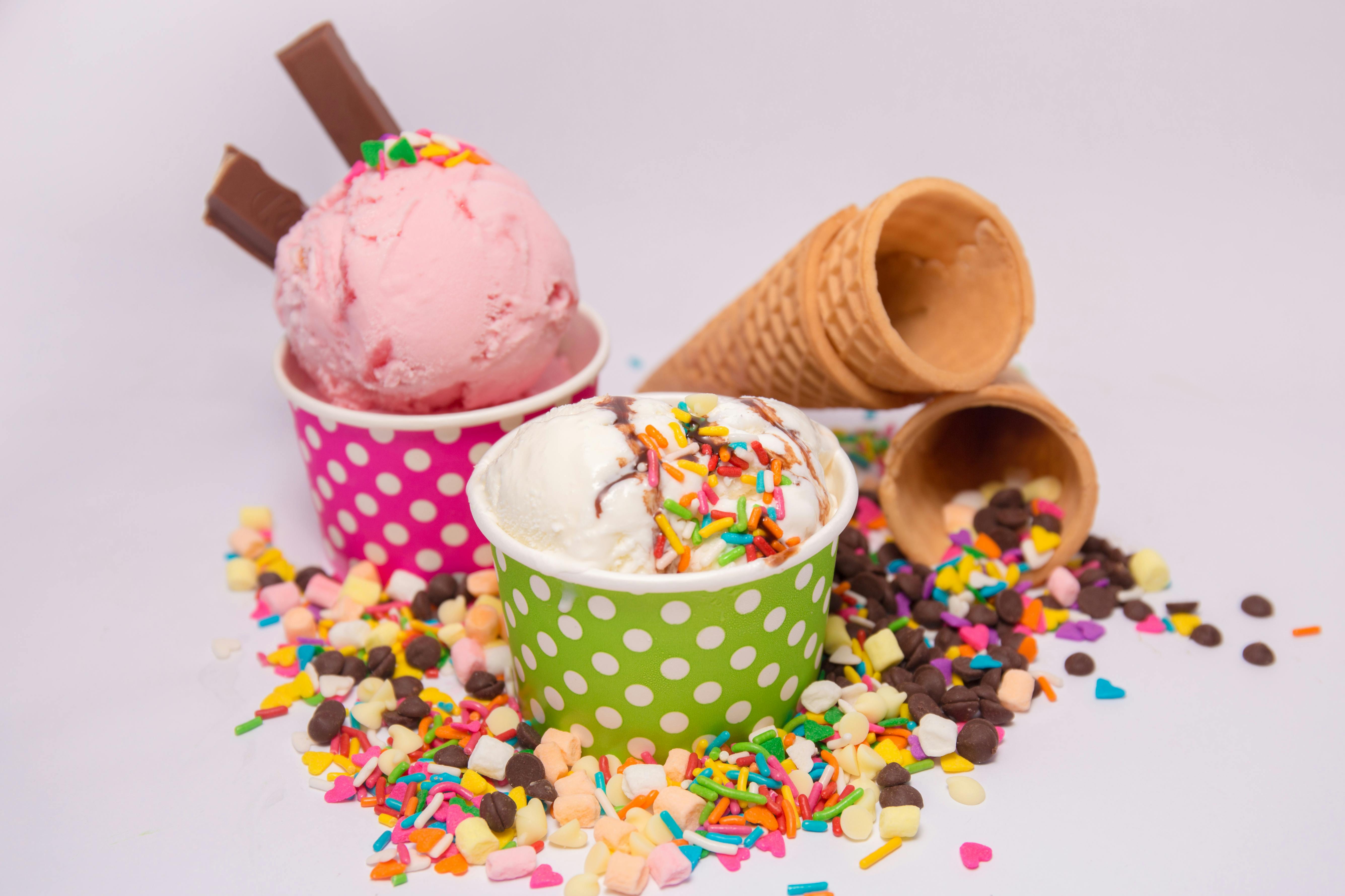 two bowls of ice cream decorated for a portrait with toppings surrounding them