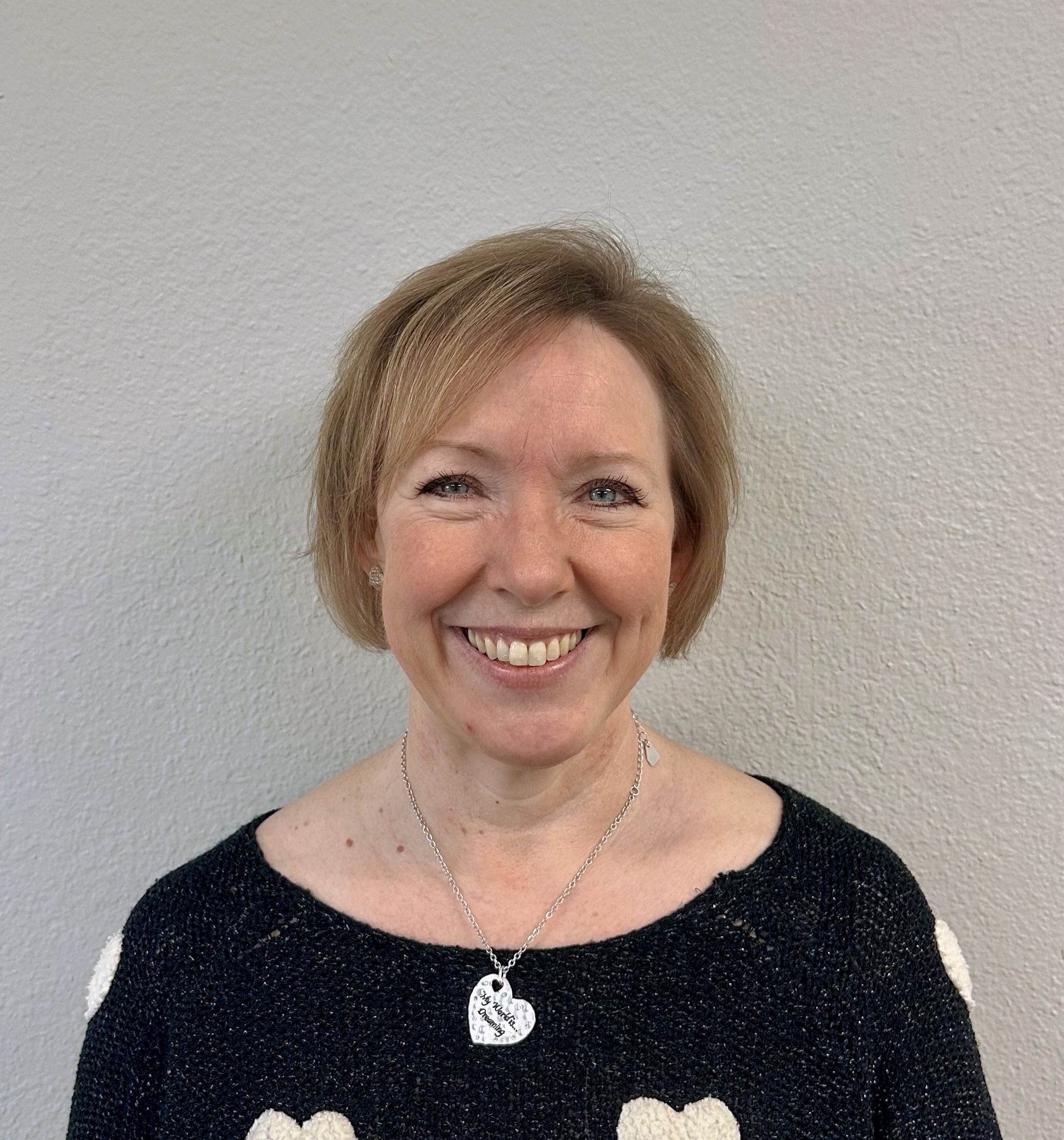 A smiling white woman with short hair