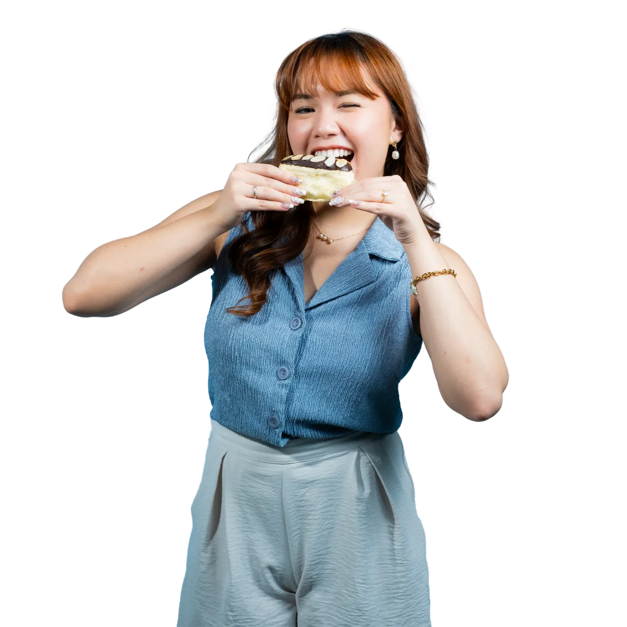 A girl eating a bread.