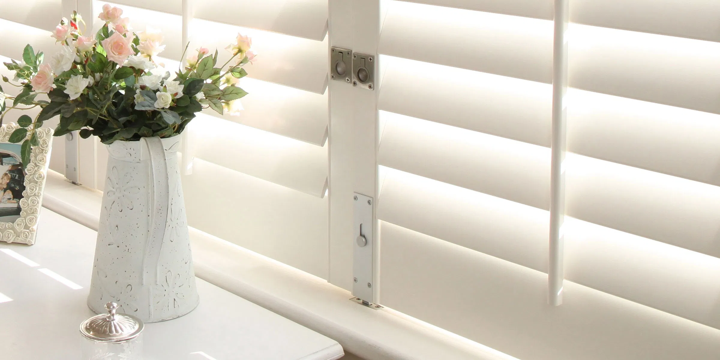 Detailed view of white shutter louvres with soft shadows and a premium painted finish