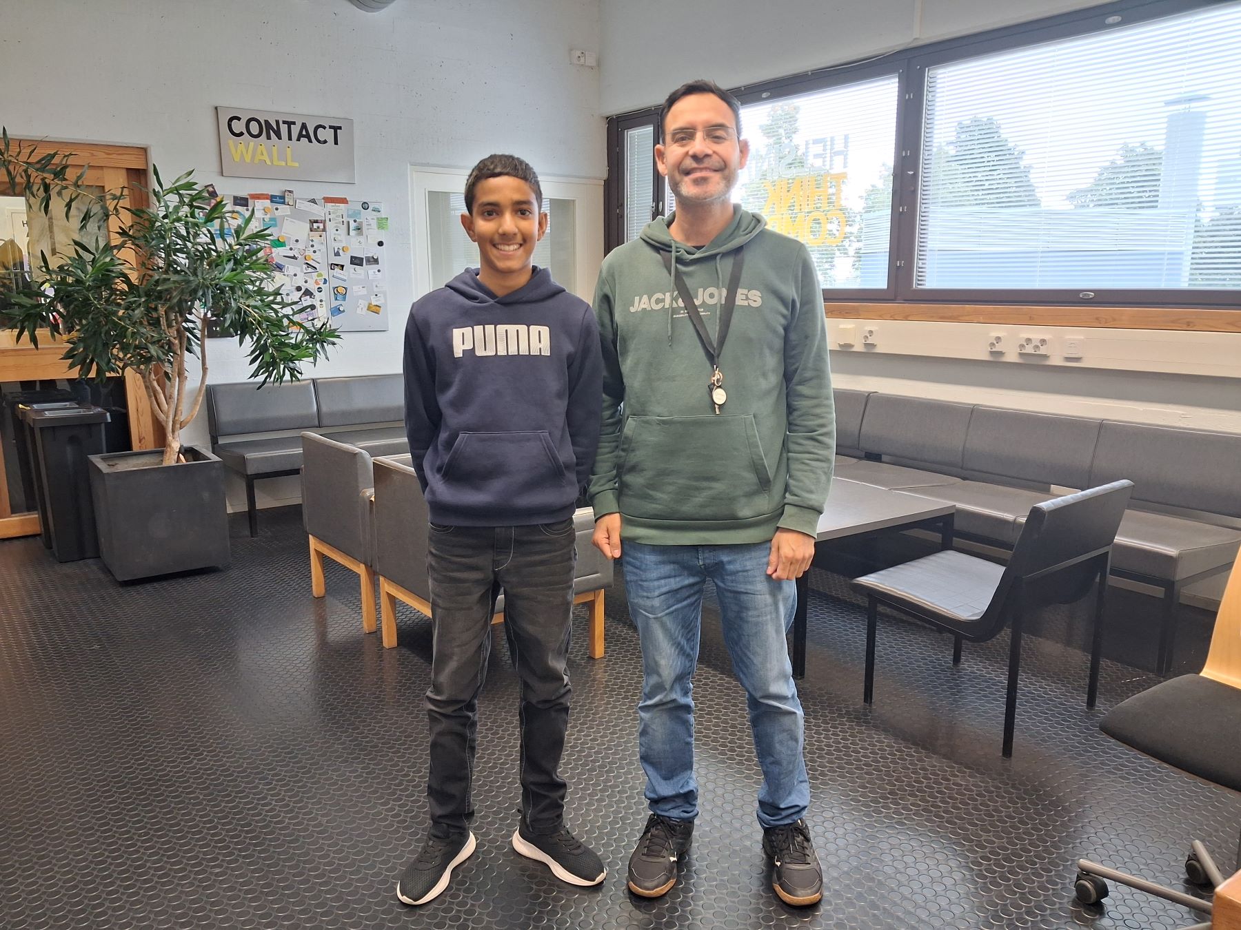Dhruv and Kashif standing in a room before the interview