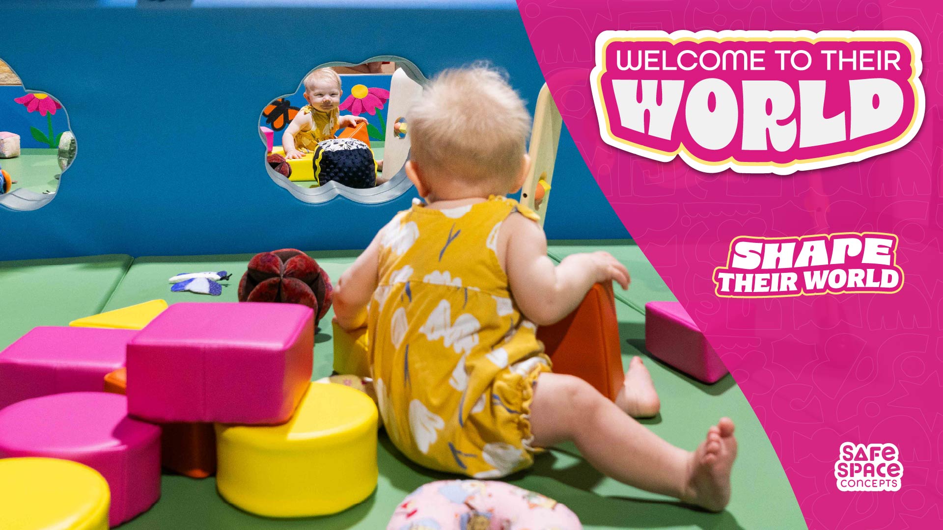 Toddler play inside an enclosed playspace made out of soft play.